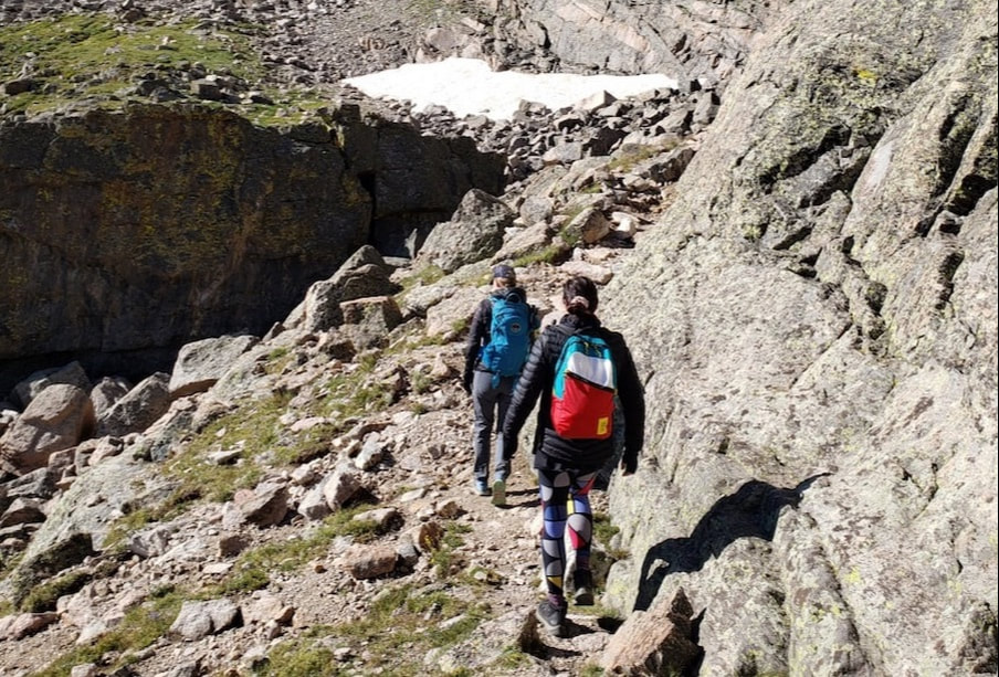 Image of two hikers on their way to Chasm Lake. RMNP